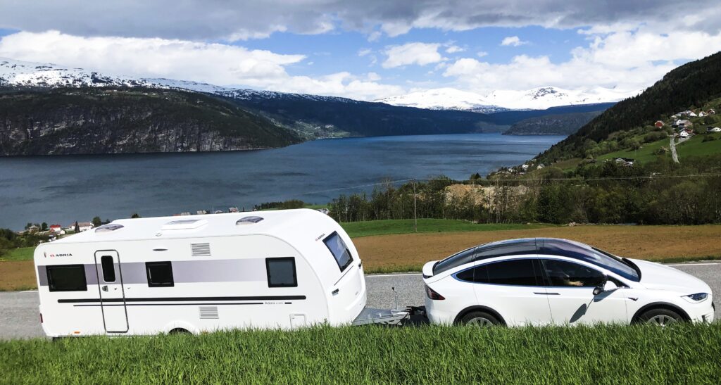 Tesla Model X towing an Adria caravan up a mountain in Norway